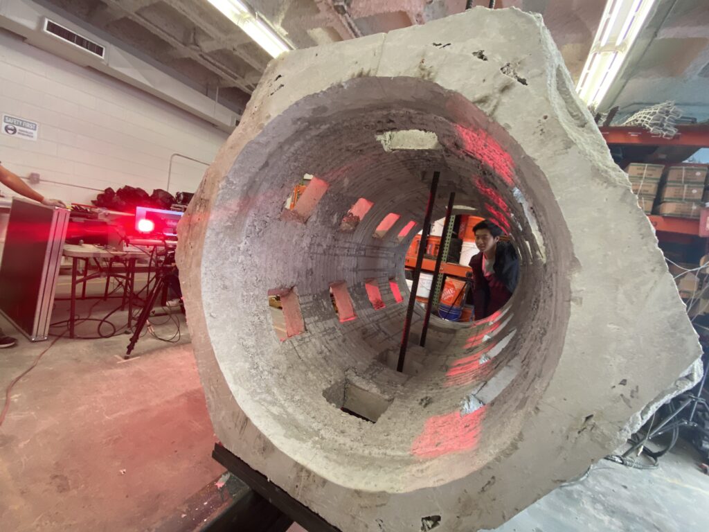 Large concrete specimen undergoing non-destructive evaluation with laser scanning